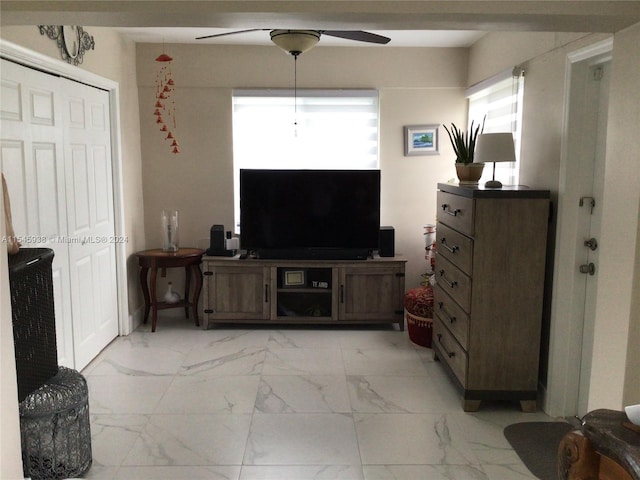 living room with light tile flooring and ceiling fan