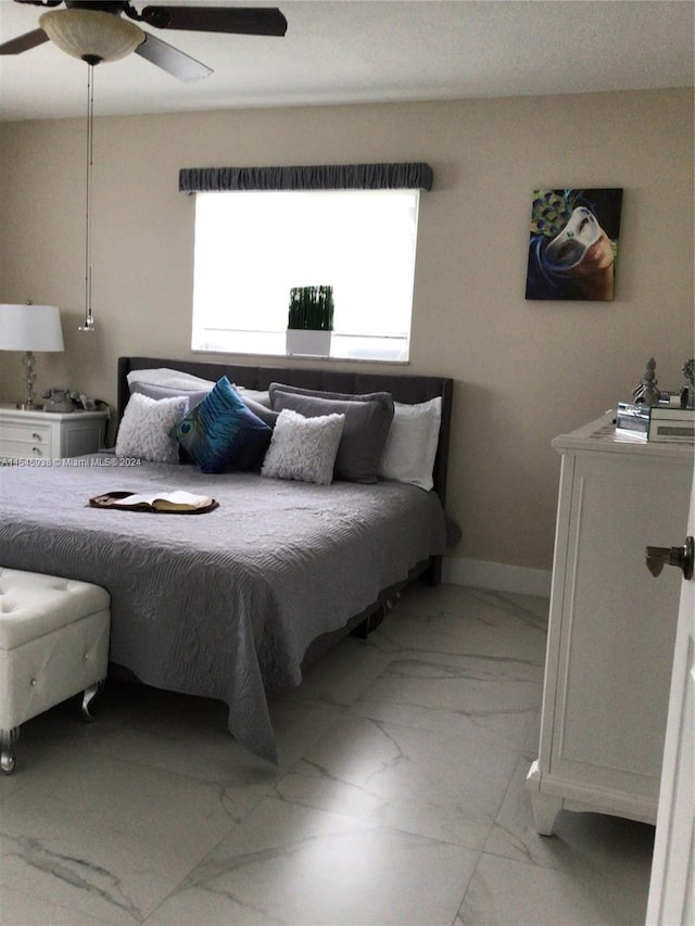 bedroom with light tile flooring and ceiling fan