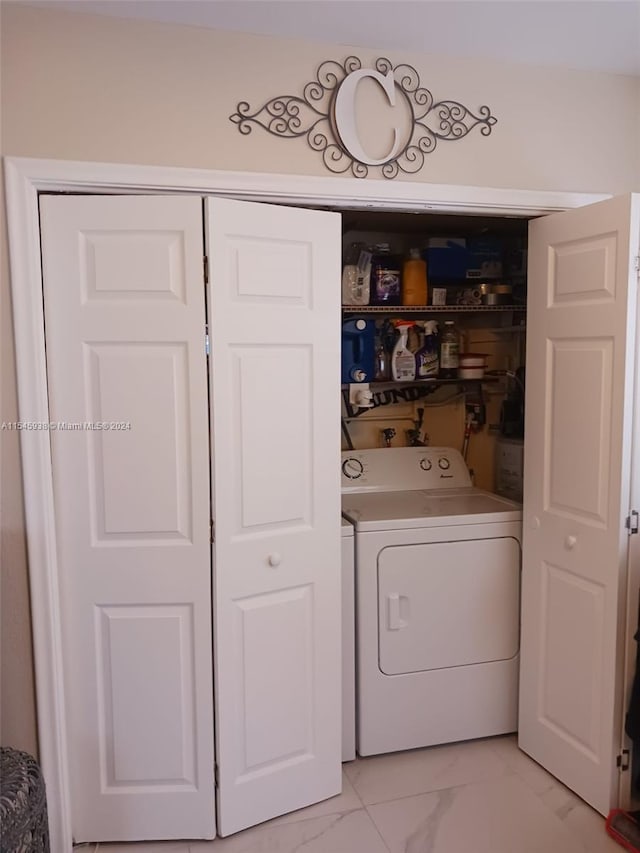 laundry area featuring washing machine and clothes dryer, washer hookup, and light tile flooring