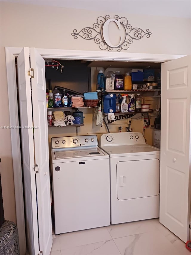 washroom with light tile flooring and washing machine and clothes dryer