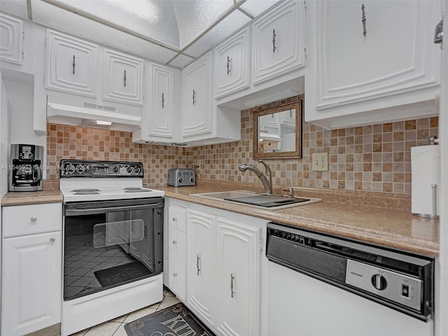 kitchen featuring light tile floors, white appliances, wall chimney exhaust hood, white cabinets, and sink