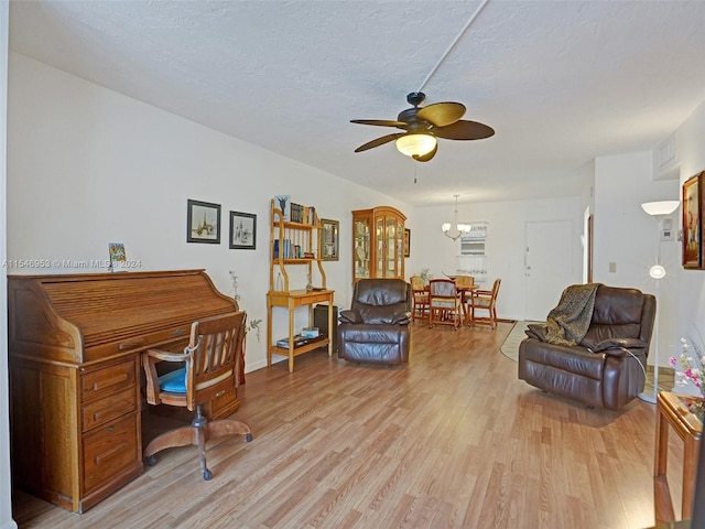 office space featuring light hardwood / wood-style floors and ceiling fan with notable chandelier