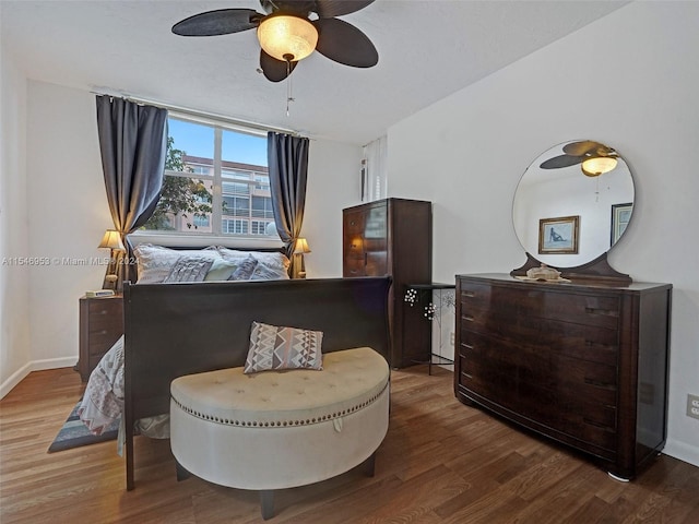 bedroom featuring ceiling fan and dark wood-type flooring