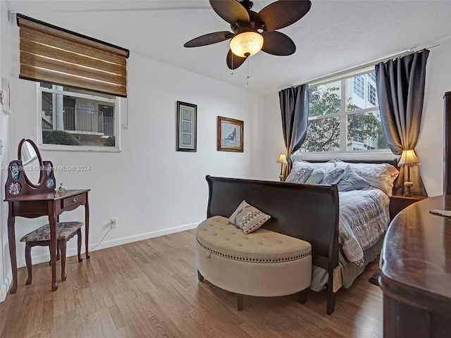 bedroom with dark hardwood / wood-style floors and ceiling fan