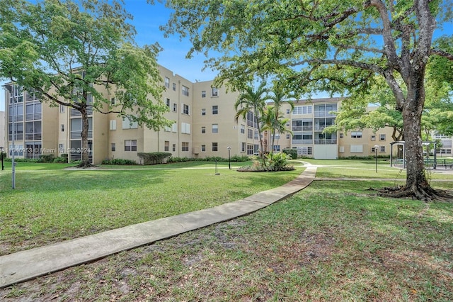 view of property's community with a lawn