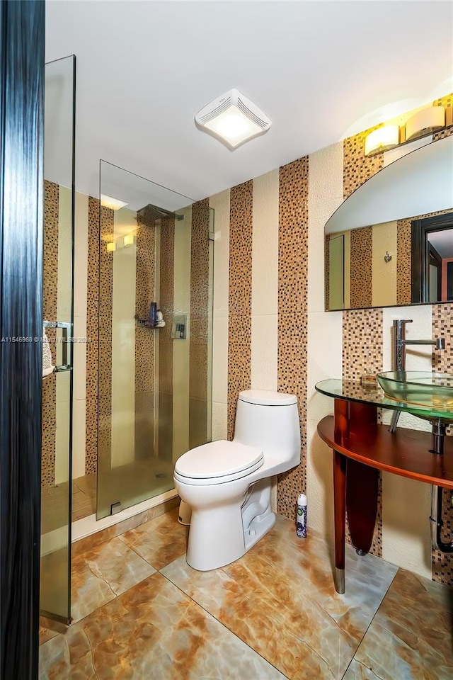 bathroom with toilet, a shower with door, vanity, tasteful backsplash, and tile floors