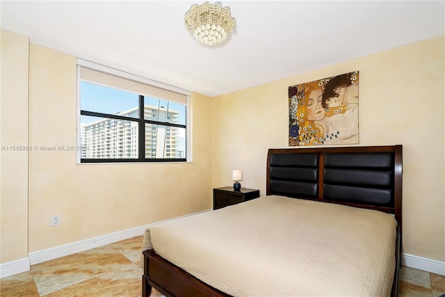 bedroom featuring light tile flooring and a chandelier