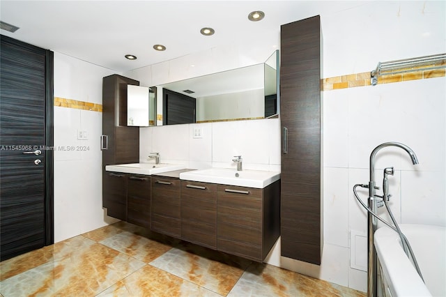 bathroom featuring backsplash, tile walls, double sink, and tile floors