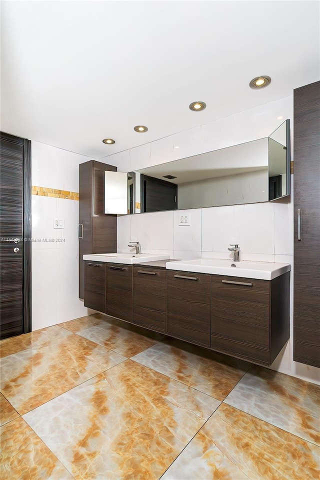 bathroom with double sink vanity and tile flooring