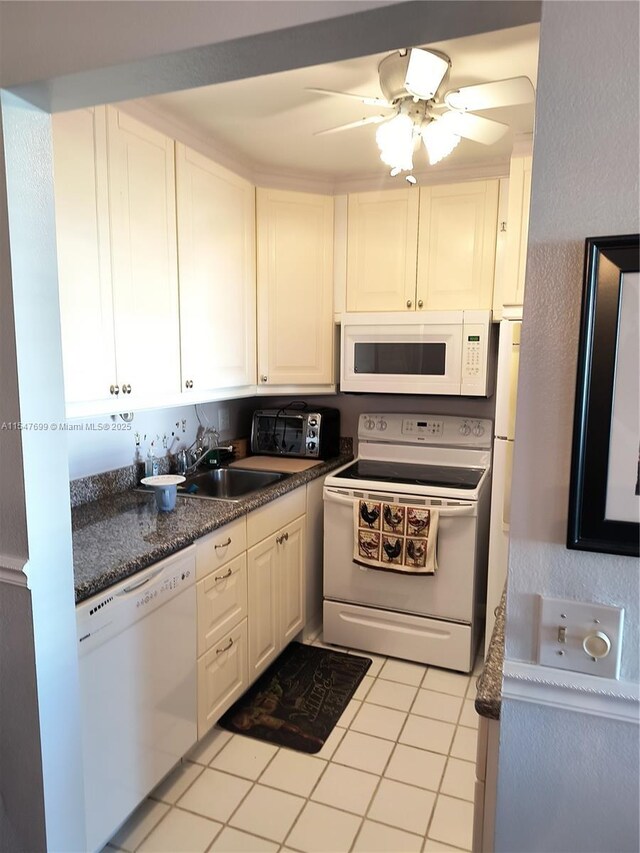 kitchen featuring white cabinetry, sink, ceiling fan, white appliances, and light tile patterned floors