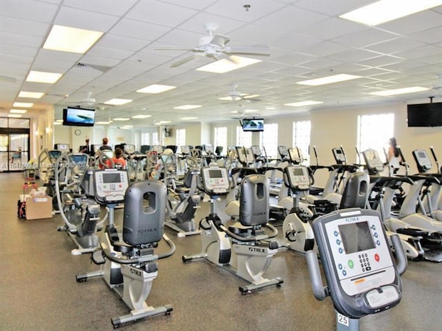 exercise room with a drop ceiling and ceiling fan