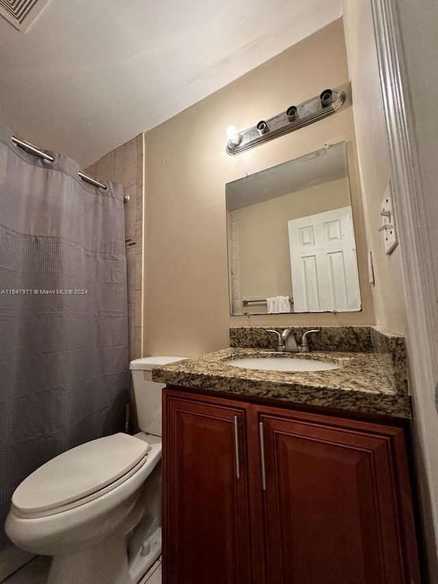 bathroom featuring large vanity and toilet