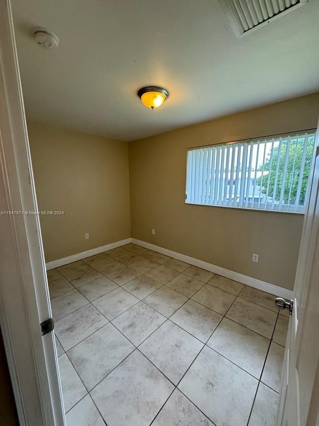 empty room featuring light tile floors