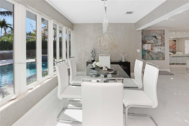 dining space featuring an inviting chandelier and plenty of natural light