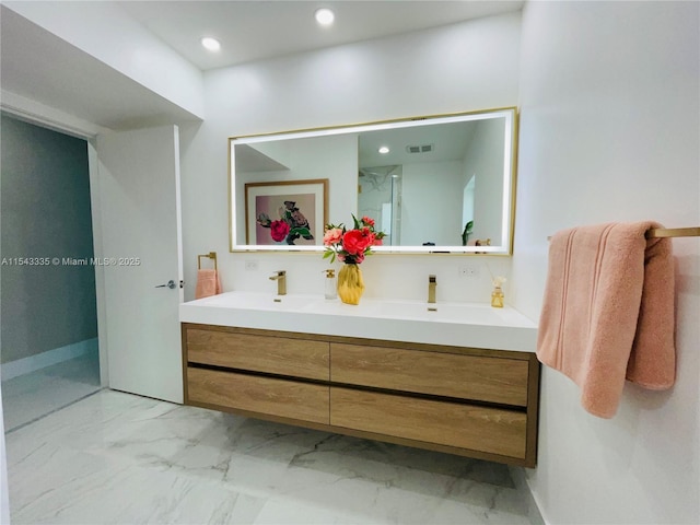 bathroom featuring a shower and vanity