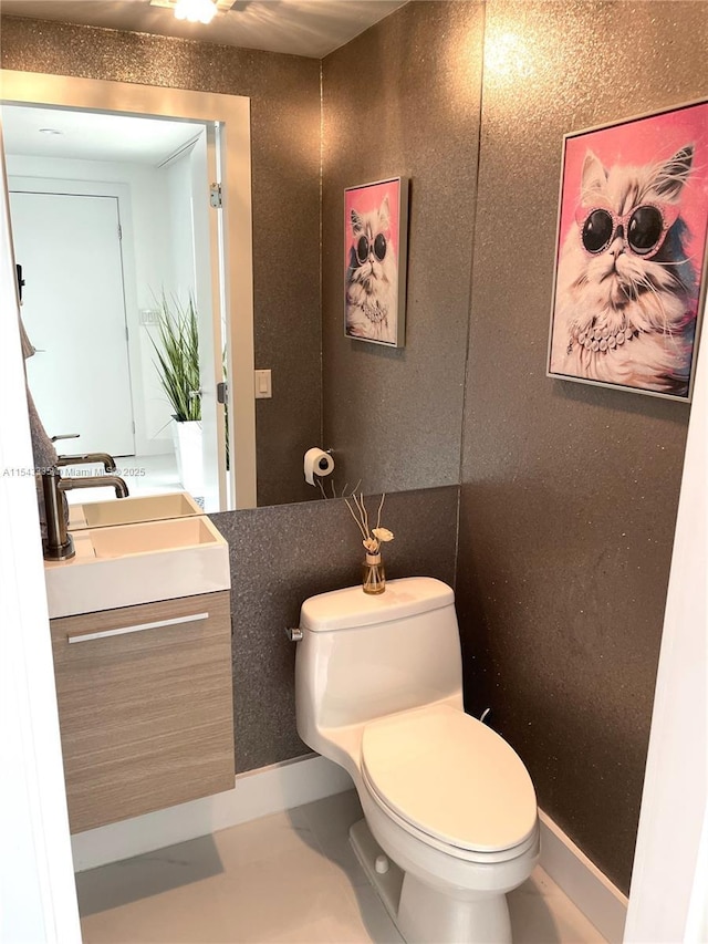 bathroom featuring toilet and vanity