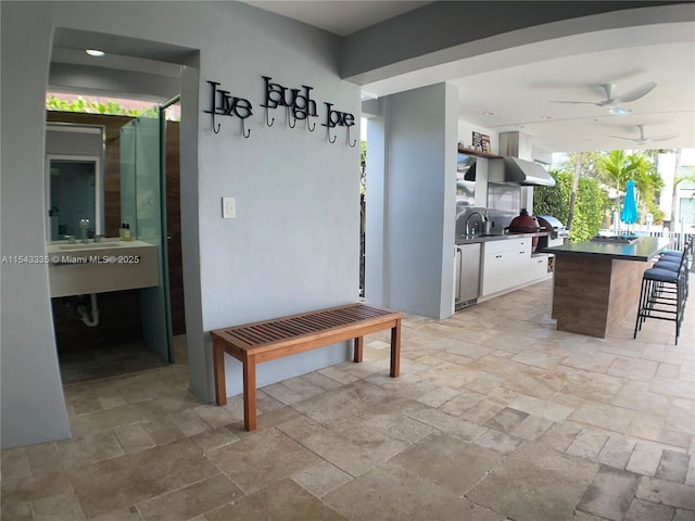 interior space with ceiling fan and sink