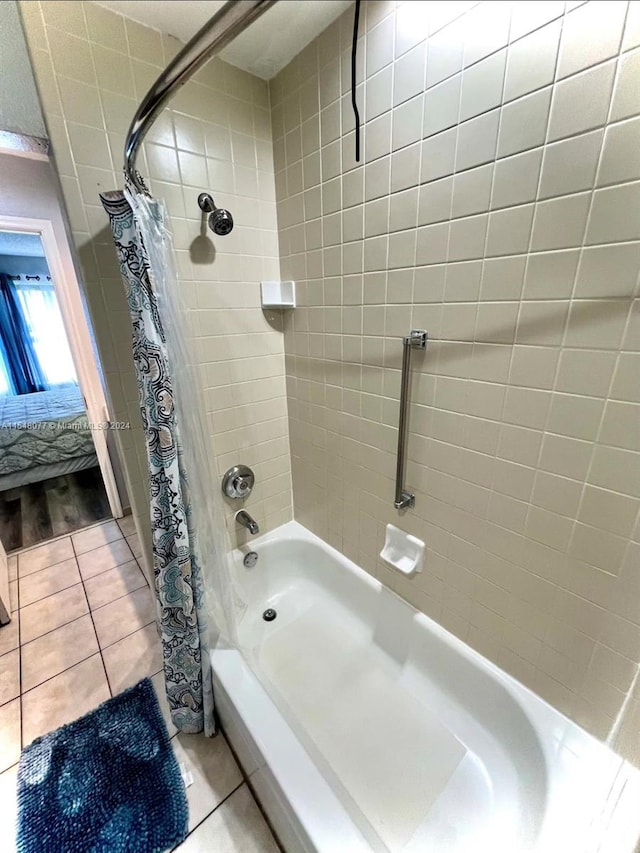 bathroom featuring shower / bath combination with curtain and tile floors