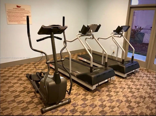 workout room with dark colored carpet