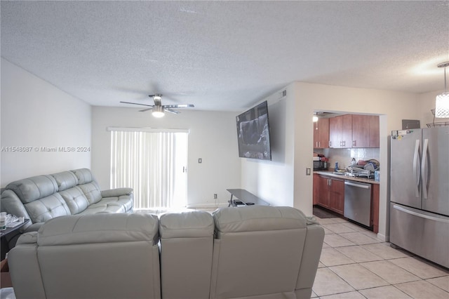 tiled living room featuring ceiling fan and a textured ceiling