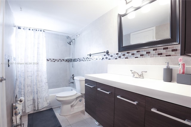 full bathroom featuring shower / bathtub combination with curtain, tile patterned flooring, toilet, vanity, and tile walls