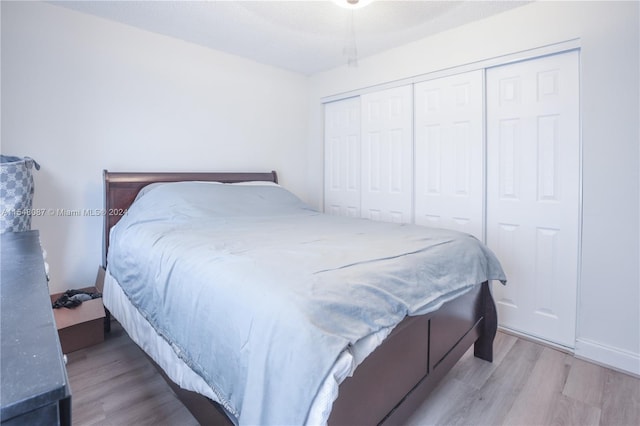 bedroom with a closet and light hardwood / wood-style floors