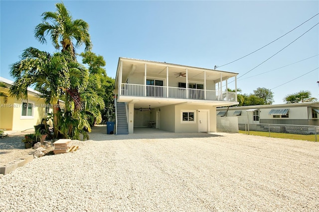 view of front of house featuring ceiling fan and a carport