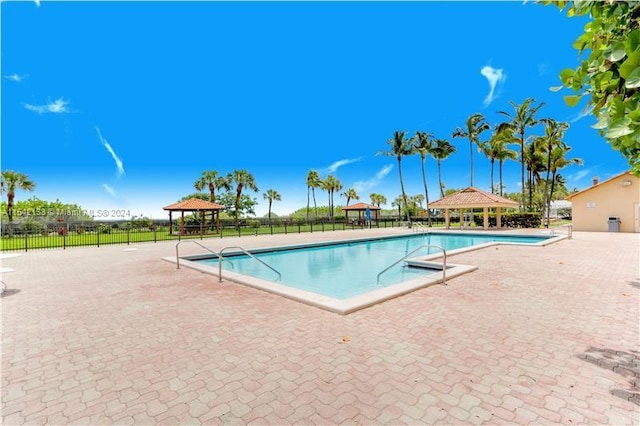 view of swimming pool with a gazebo and a patio area