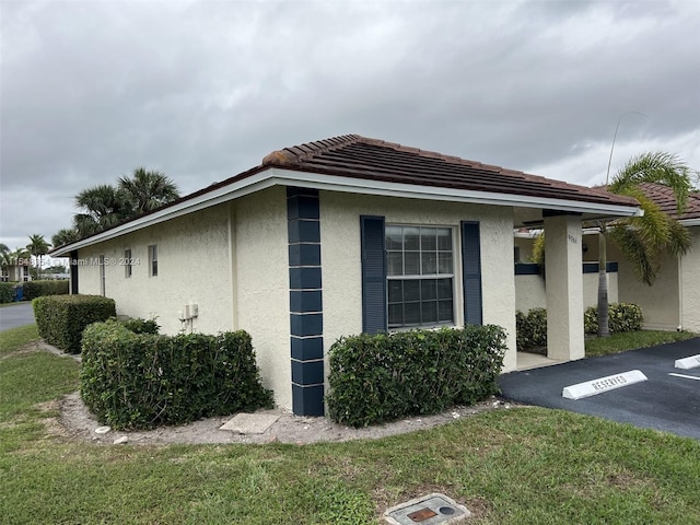 view of side of property with a yard