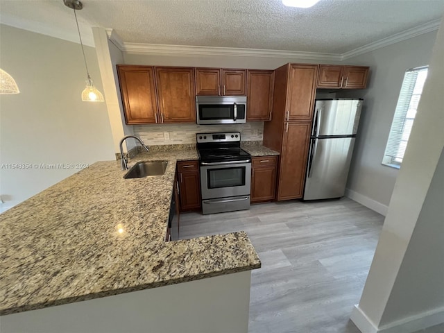 kitchen with hanging light fixtures, stainless steel appliances, light stone countertops, and backsplash