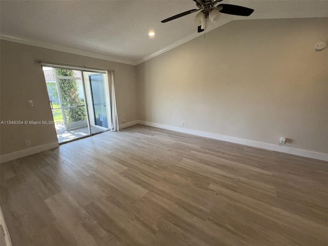 unfurnished room with lofted ceiling, ceiling fan, and light wood-type flooring