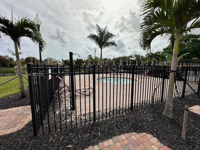 view of gate with a fenced in pool