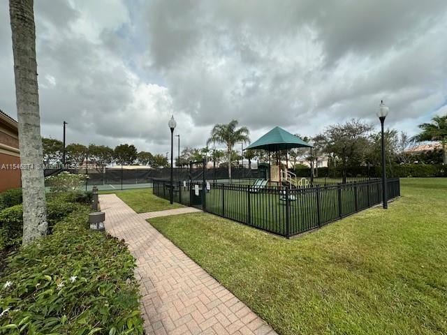 view of community featuring a playground and a lawn