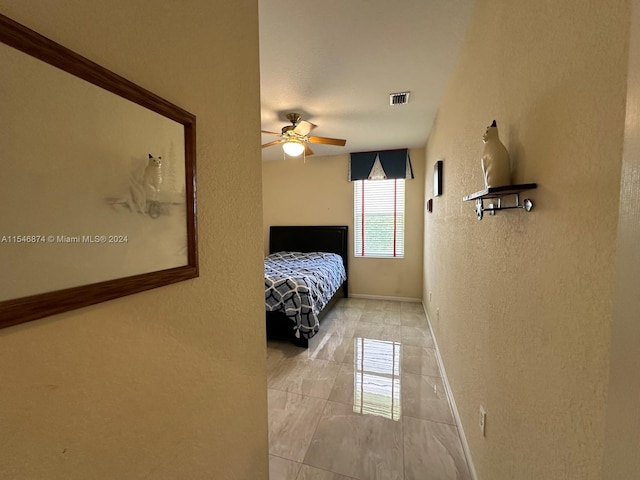 unfurnished bedroom featuring light tile patterned floors and ceiling fan