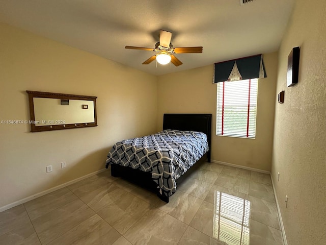 bedroom featuring ceiling fan and light tile patterned floors