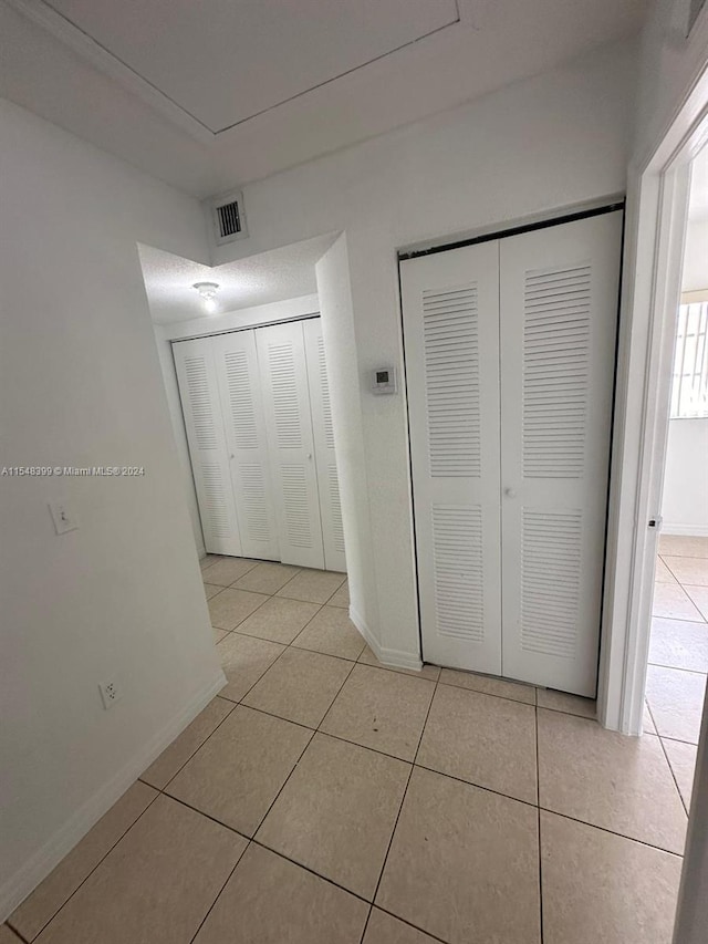 unfurnished bedroom featuring light tile floors