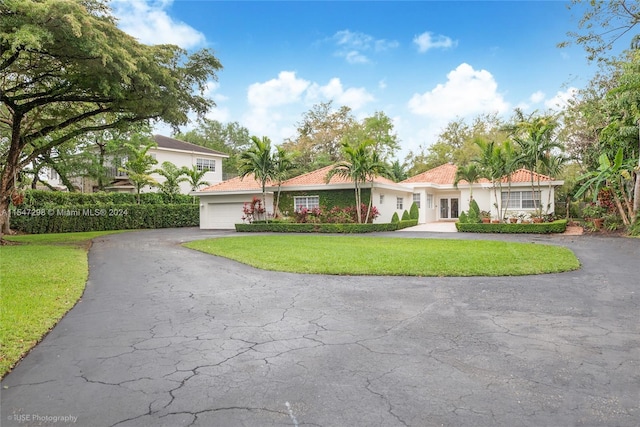 view of front facade with a front yard and a garage