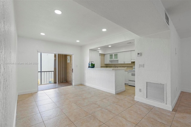 unfurnished living room featuring light tile floors