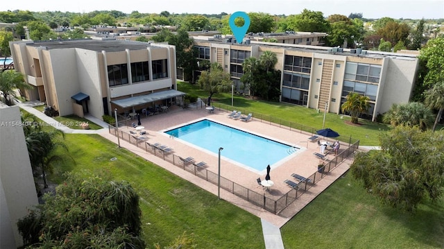 view of swimming pool featuring a yard and a patio area