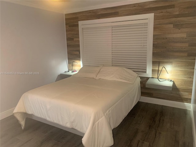 bedroom featuring dark hardwood / wood-style floors and wood walls