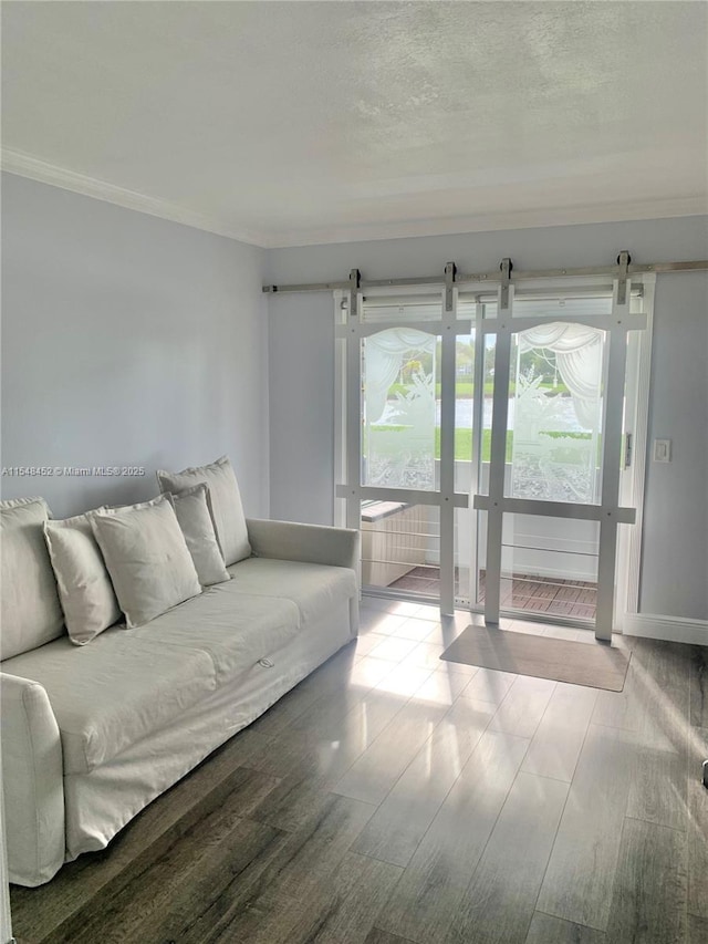 unfurnished living room featuring hardwood / wood-style floors and ornamental molding