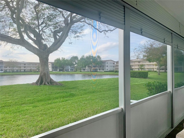 unfurnished sunroom with plenty of natural light and a water view