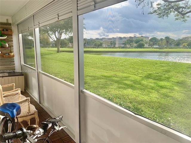 unfurnished sunroom with a water view