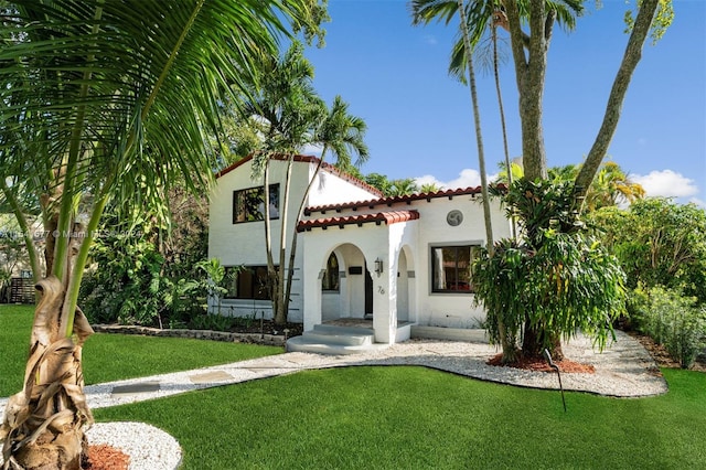 mediterranean / spanish-style house featuring a front yard