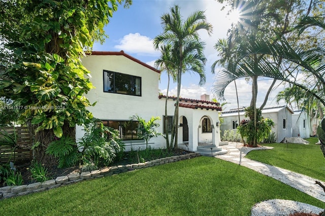 mediterranean / spanish-style home featuring a front lawn