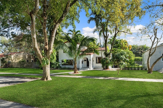 mediterranean / spanish house featuring a front lawn