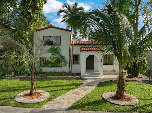 mediterranean / spanish-style home with a front lawn