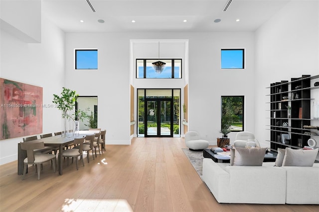 living room featuring a high ceiling and hardwood / wood-style flooring