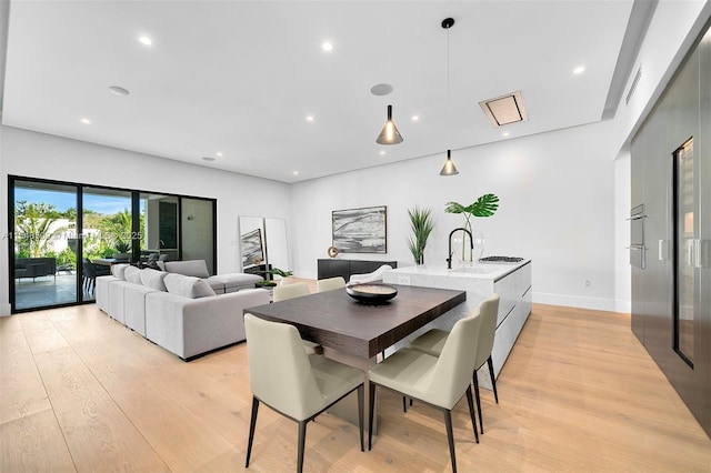 dining space with light wood-type flooring