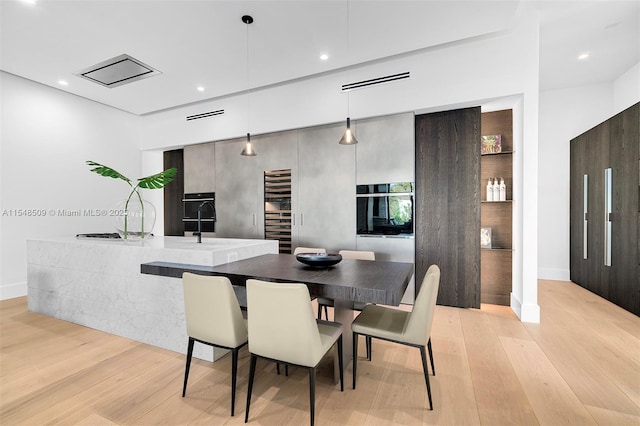 dining space featuring light wood-type flooring